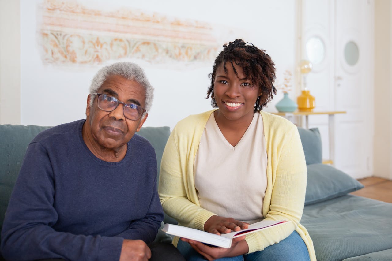 Caring moment between a senior man and a supportive woman at home, fostering connection and well-being.